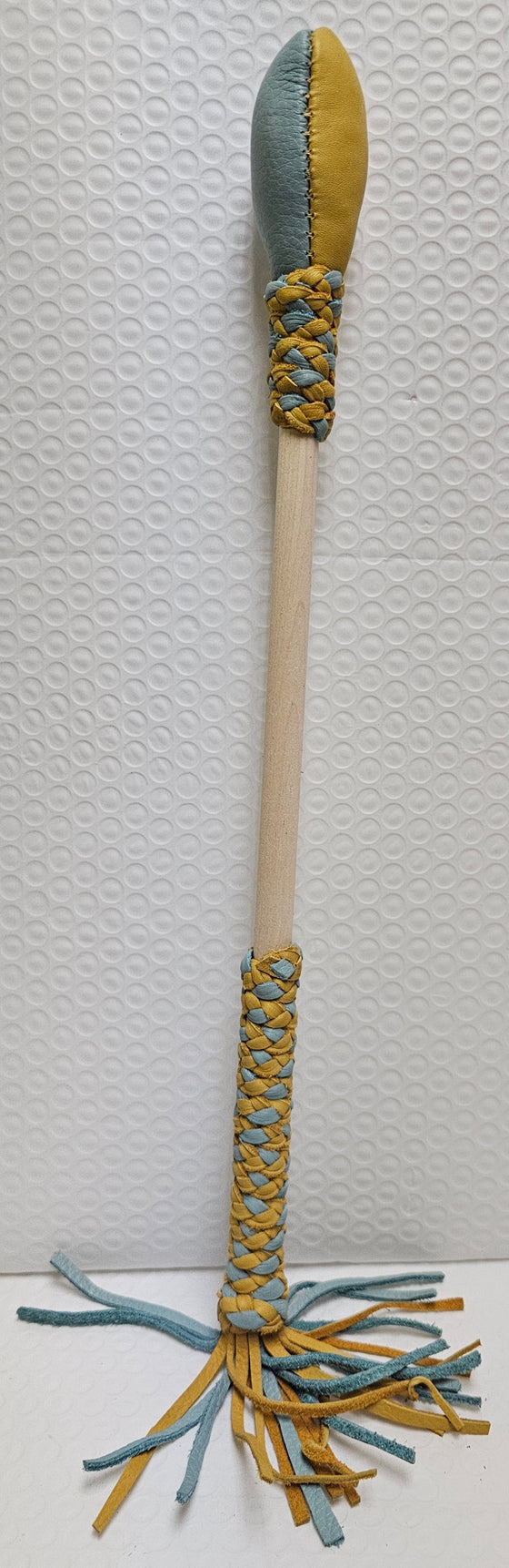 Blue and tan drum stick